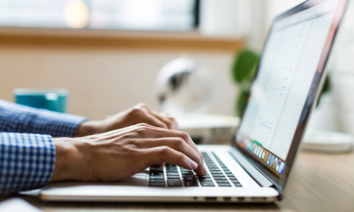 Man typing on a laptop