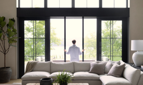 Individual looking out of doorway into their yard